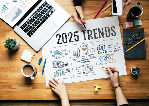 Team analyzing 2025 digital marketing trends with charts and strategy notes on a wooden desk